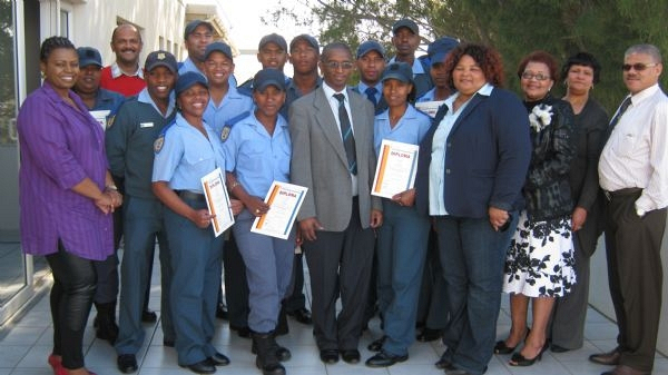 Kouga Executive Mayor Booi Koerat (centre), Social Services portfolio councillor Thandeka Maseti (forth right) and Social Services director Japie Jansen (right) joined Kouga Skills Development officials and proud parents in congratulating the 12 young people who completed their training as traffic officers.