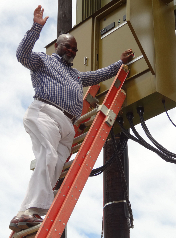 Ward councillor Phumzile Oliphant prepares to switch on the electricity to Phola Park and Shukushukuma in Humansdorp.