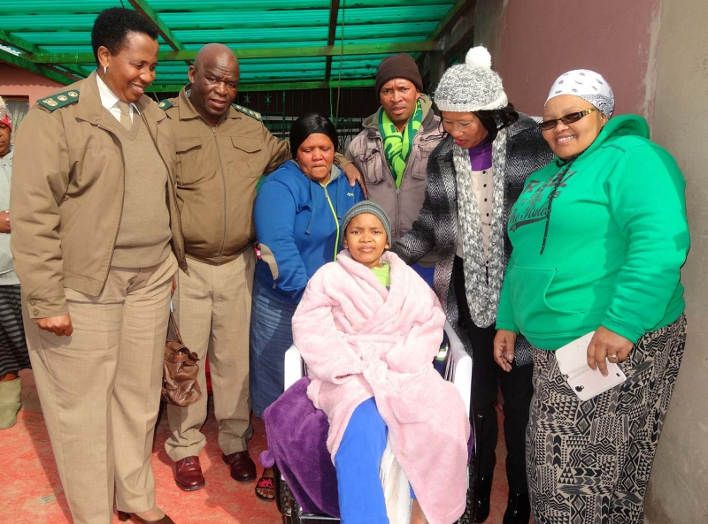 Likhona Antoni sits proudly in her new wheelchair. With her are Correctional Services deputy Regional Commissioner Nozipiwo Dumbela, Regional Commissioner Nkosinathi Breakfast, her parents Lindiwe and Whitey, Kouga Mayor Daphne Kettledas and Sindi Meleni, representing her husband, ward councillor Timothy Meleni. 