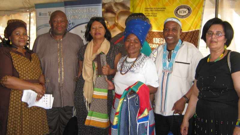 Misiwe Jujwana of Uzuko Lwethu Sewing Projects (centre) shows some of her materials to Eastern Cape Premier Phumulo Masualle (second from right). With them are (from left) Vuyiseka Nokhenke from DSRAC, Ward 9 Councillor Xolisile Persent, Kouga Executive Mayor Daphne Kettledas and Tourism and Creative Industries Portfolio Chairperson Virginia Camealio-Benjamin.