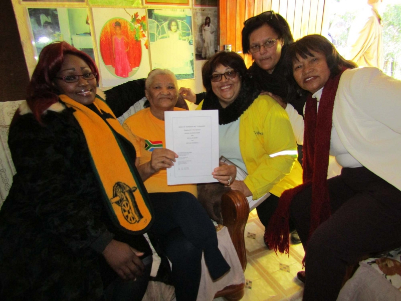 Eva Adams (second left) receives the title deed to her RDP house from Human Settlements MEC Helen Sauls-August (third left). Also there for the big occasion were Ward Councillor Bulelwa Koliti, Portfolio Councillor Virginia Camealio-Benjamin and Kouga Executive Mayor Daphne Kettledas . 