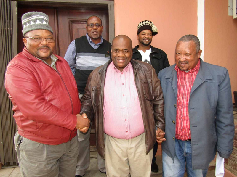 Chief Executive Officer of the Eastern Cape House of Traditional Leaders Mzwethemba Nkantsu (front centre) holds hands with traditional surgeon and Chairperson of Buyambo, a committee of traditional surgeons and nurses, Xolile Kato (front left) and Kouga Public Participation Officer Fumanekile Lloyd. With them are Monde Fulani (back left) of the Department of Health and traditional surgeon Mike Brown.